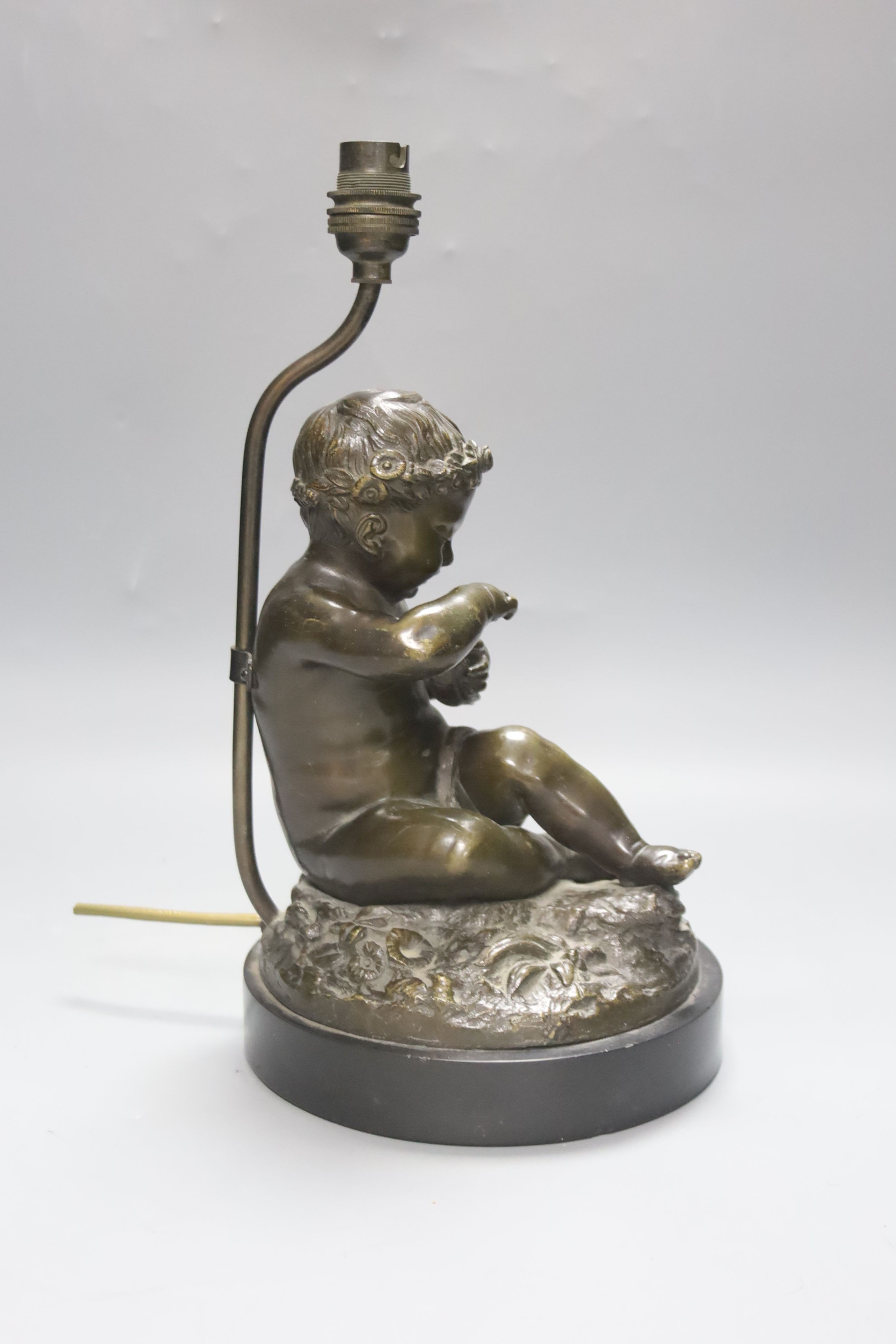 A late 19th century French bronze lamp base, putto and dove, 34cm total